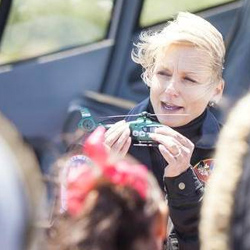 Passing on the love of flying to a new generation - Dianna talking helicopters with a group of kids