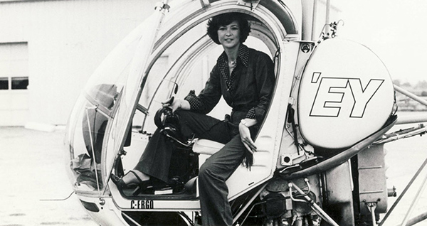 Dini posing at the controls of the helicopter that she flew as traffic reporter in Toronto.